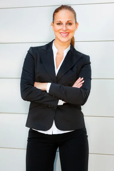 Stock image Smiling business woman with crossed arms on chest standing at office buildi