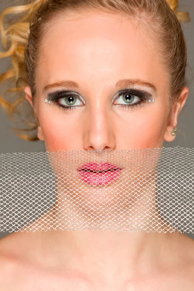 Portrait of fashion girl closing lips with textile — Stock Photo, Image