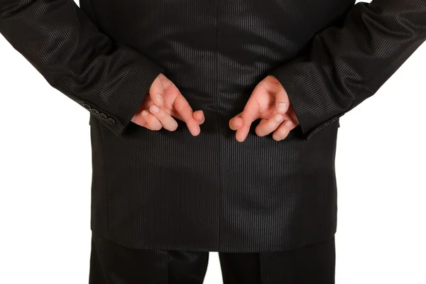 Businessman holding crossed fingers behind back. Close-up. Royalty Free Stock Images