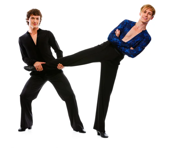 Ballroom male dancer holding leg of his funny posing friend — Stock Photo, Image