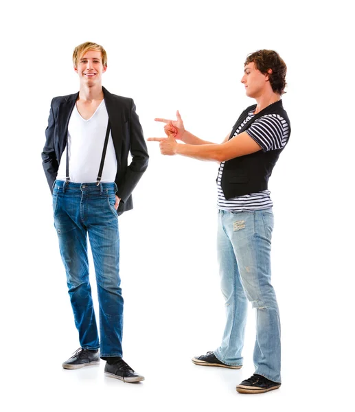 Young man pointing on his friend. Isolated on white — Stock Photo, Image