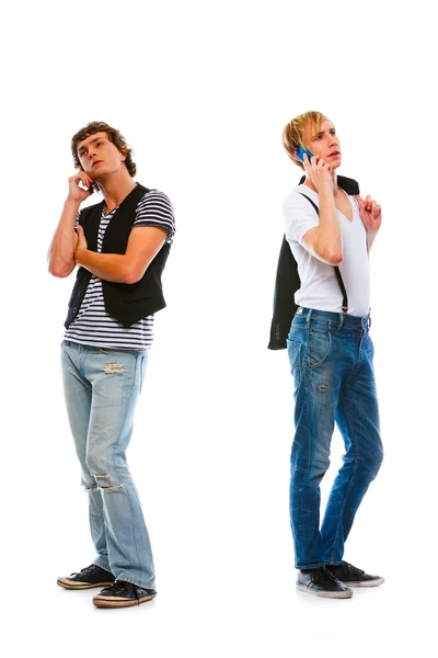 Two modern young men talking mobile. Isolated on white — Stock Photo, Image