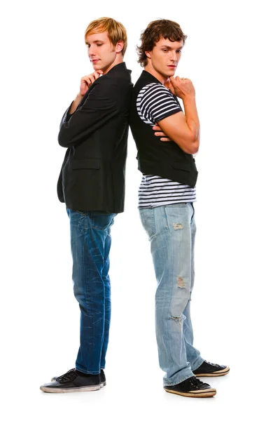 stock image Two thoughtful modern young men standing back to back. Isolated