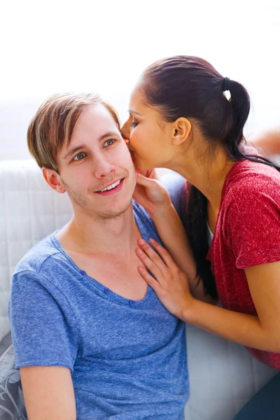 Girl whispering something in ear of her excited boyfriend — Stock Photo, Image