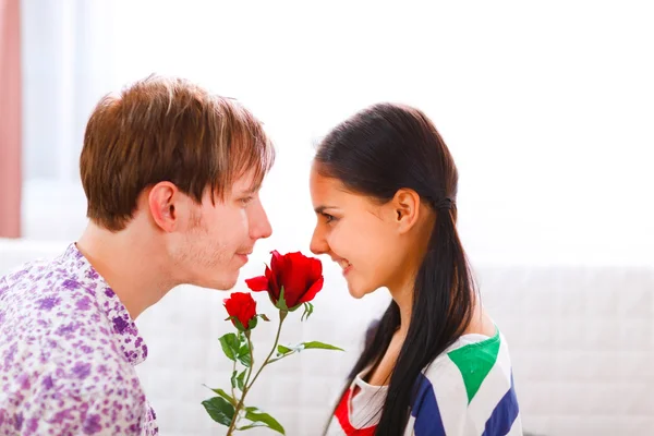 Genç bir adam kız arkadaşına çiçek sunuyor. — Stok fotoğraf