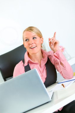 Pleased business woman got idea while sitting at office desk. Idea gesture clipart