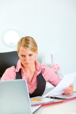 Serious modern business woman holding document clipart