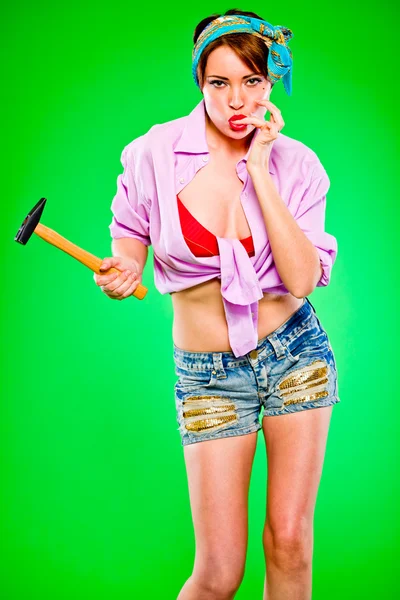 Sensual girl licking fingers striked by hammer. Pin-up and retro style . — Stock Photo, Image