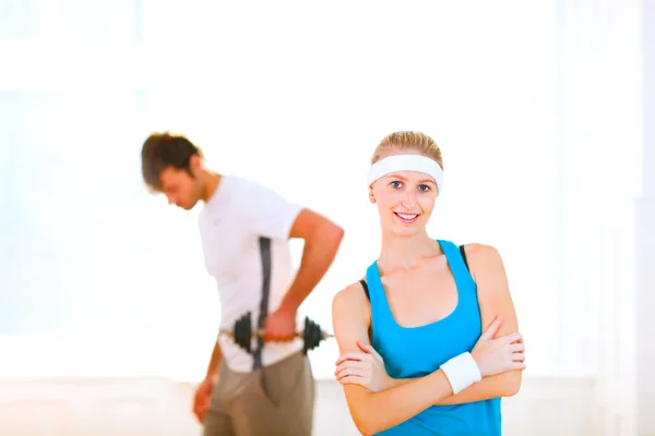 Portrait of slim girl in sportswear and man making sport exercis — Stock Photo, Image