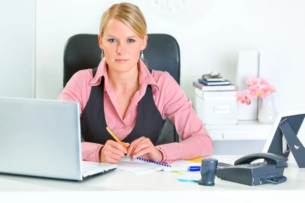 Mujer de negocios autorizada sentada en el escritorio de la oficina — Foto de Stock