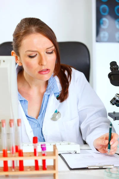 Busy female medical doctor working at her office — Stock Photo, Image