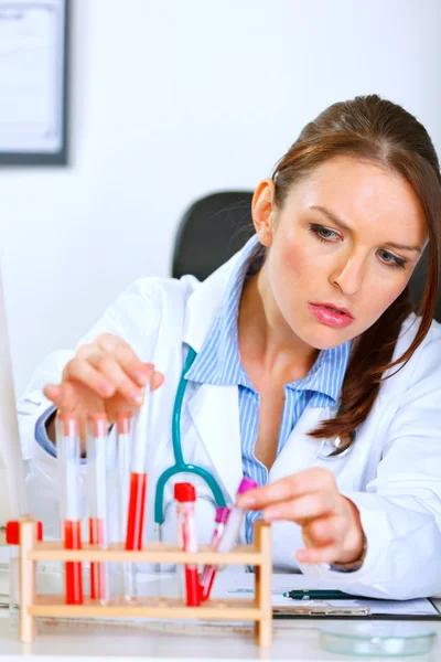 Läkare kvinna som arbetar med rör i laboratorium — Stockfoto