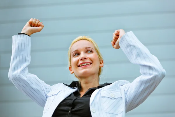 Excited business woman standing at office building — Stock Photo, Image