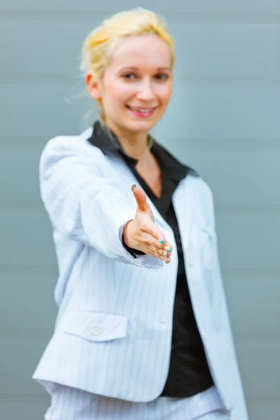 Smiling business woman stretches out hand for handshake — Stock Photo, Image