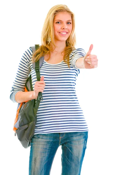Glad söt flicka med ryggsäck visar tummen upp gest — Stockfoto