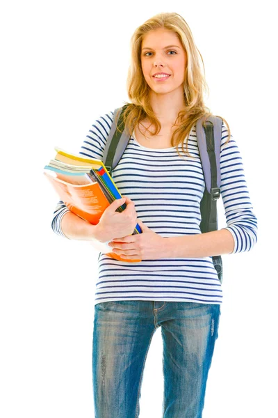 S úsměvem mladá dívka s školní učebnice drží v rukou — Stock fotografie