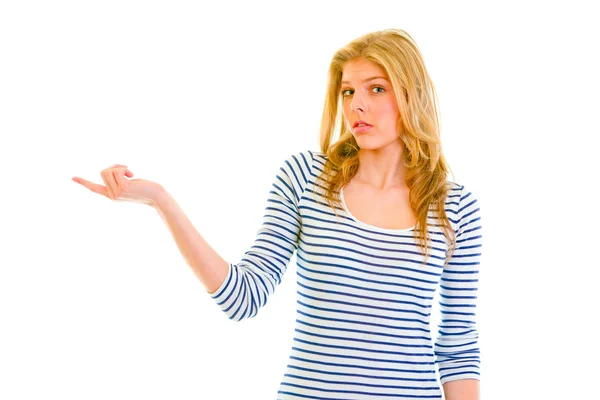 Confused teen girl pointing in corner — Stock Photo, Image