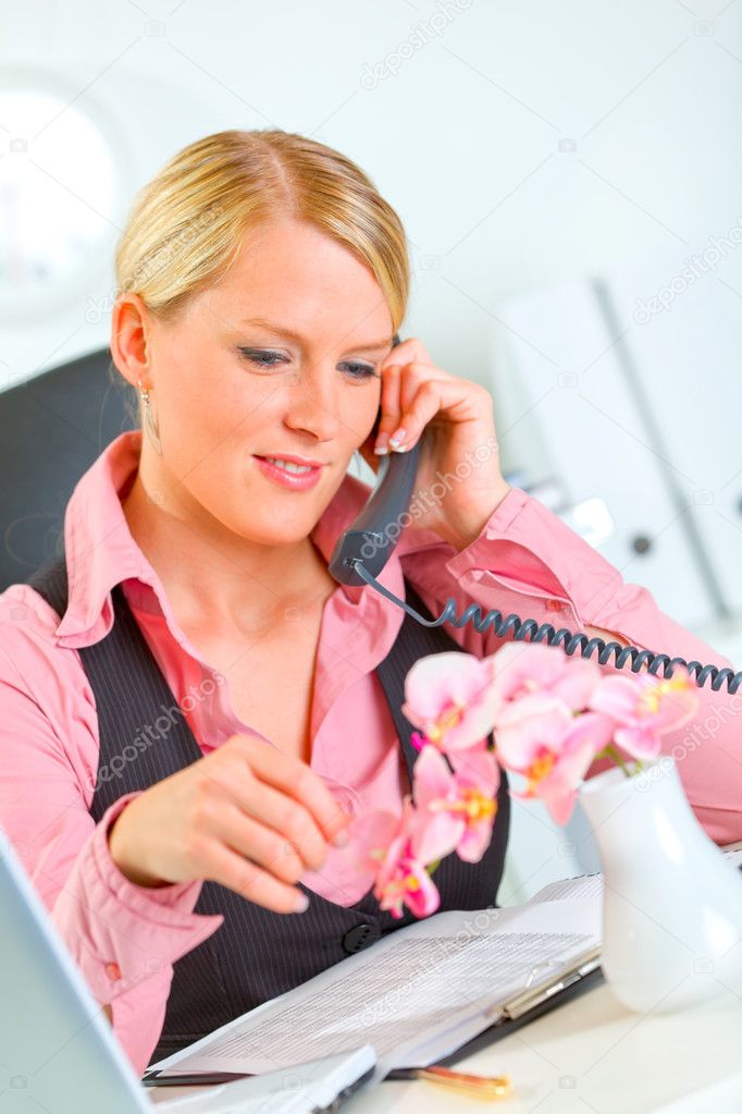 Happy business woman carefree talking phone in office
