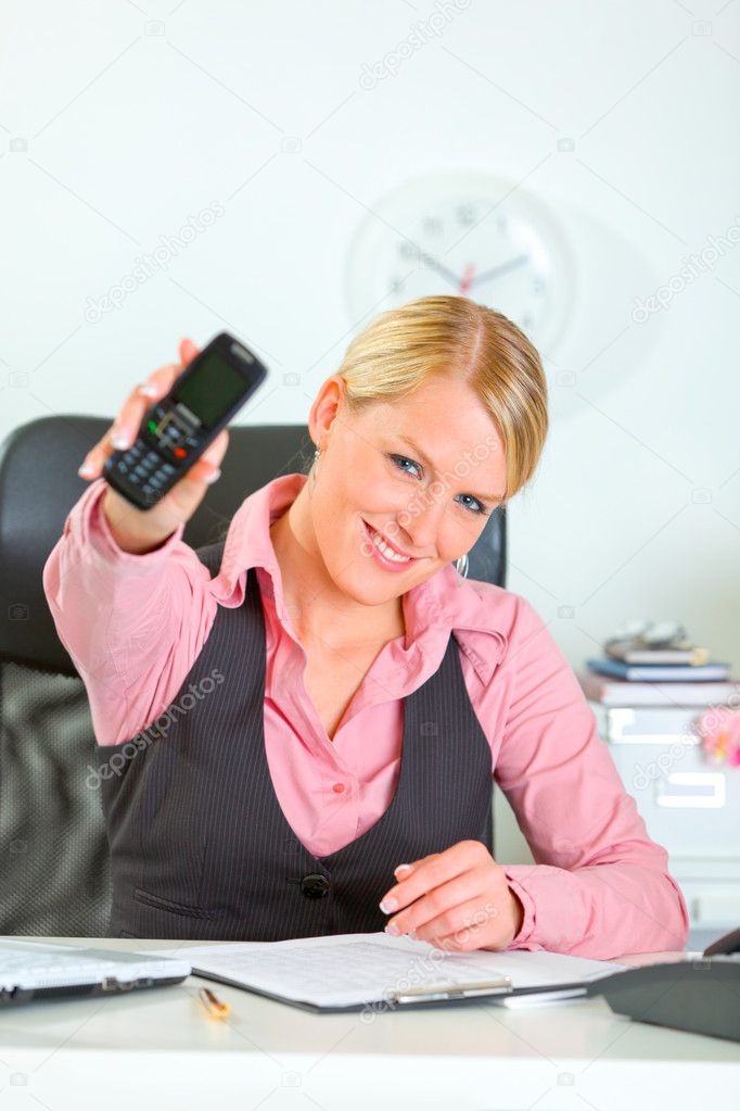 Cheerful modern female manager showing mobile phone