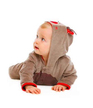 Baby in costume of Santa Claues reindeer looking in corner clipart