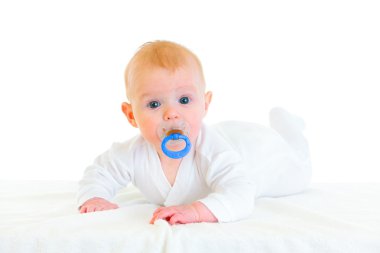 Sweet four month old baby with soother laying on diaper clipart