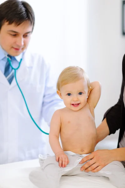Retrato del bebé feliz siendo revisado por el médico pediátrico utilizando un — Foto de Stock