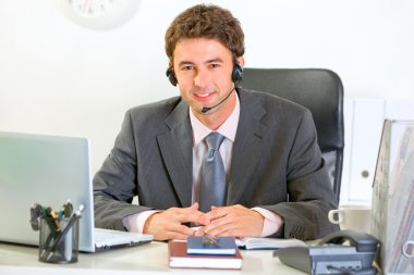 Portrait of smiling modern manager with headset clipart