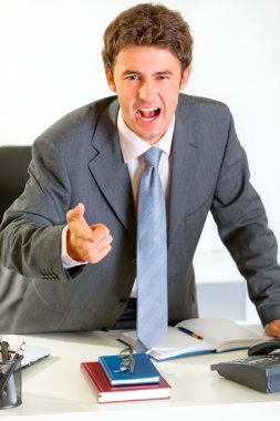 Angry modern businessman shouting and pointing on you clipart