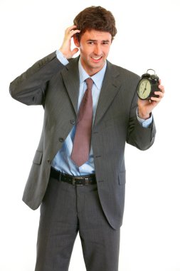 Concerned about time modern businessman with alarm clock clipart