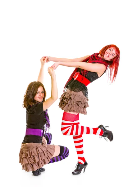 Smiling pretty girl squatting and holding her girlfriends hands — Stock Photo, Image