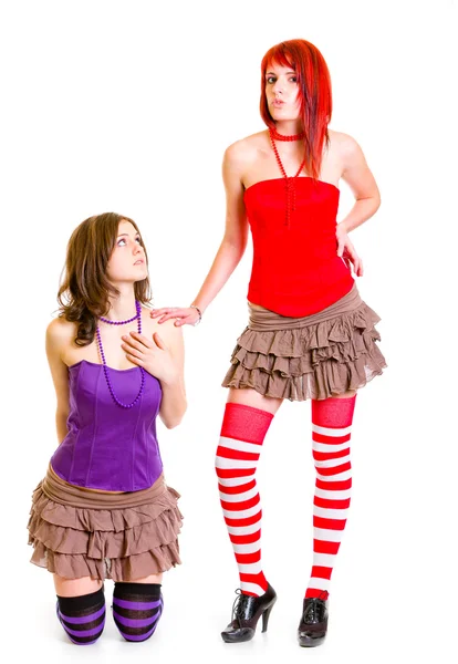 Young girl on knees pleading her strict girlfriend — Stock Photo, Image