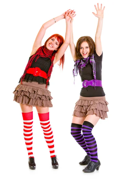 Two cute happy girlfriends standing with hands raised up — Stock Photo, Image