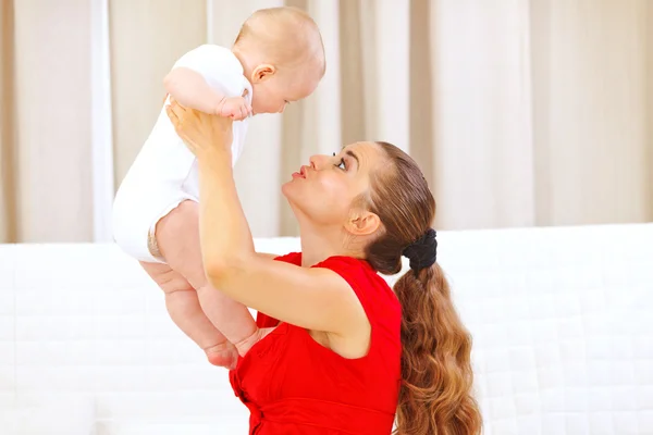 Gelukkig Mama holding glimlachend schattige baby in handen en spelen — Stockfoto