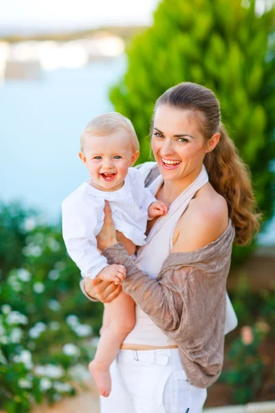 Portrait of beautiful mother with cute little baby on street — Stock Photo, Image