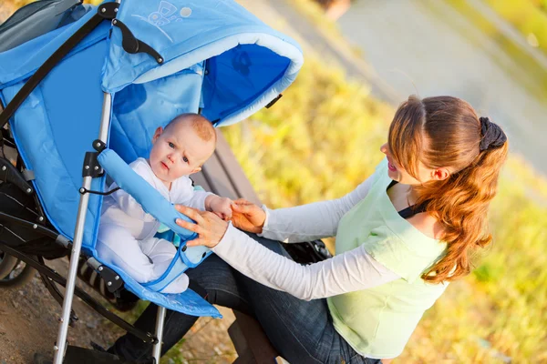 stock image Happy mother holding baby's hand