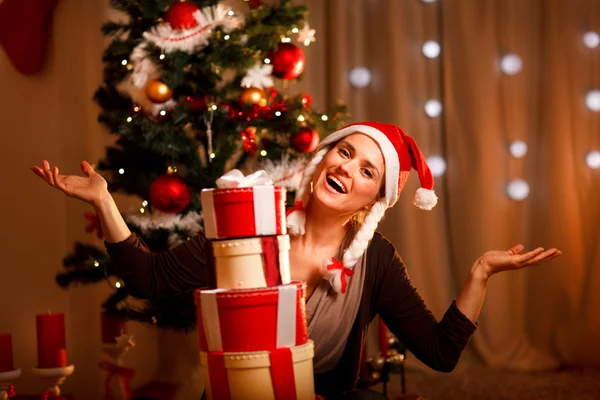 Ευτυχισμένη γυναίκα κοντά χριστουγεννιάτικο δέντρο με πύργο του παρόντος κουτιά — Φωτογραφία Αρχείου