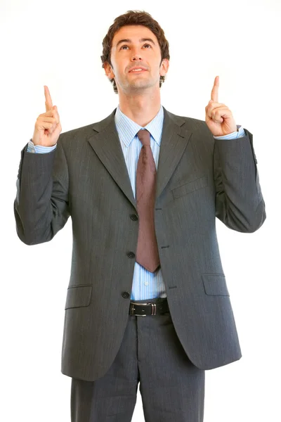 Interested modern businessman pointing finger up at copy space — Stock Photo, Image