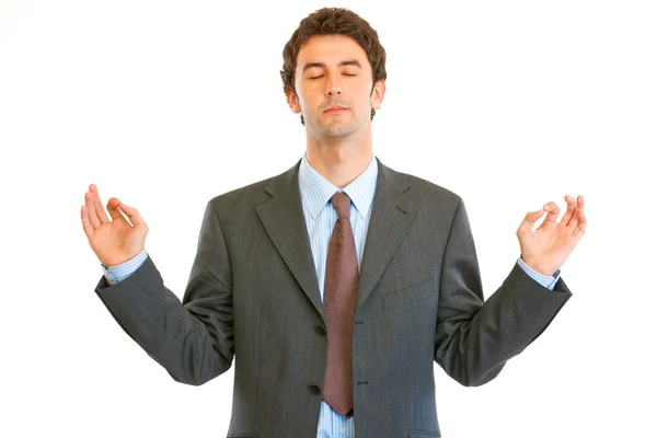Meditando homem de negócios moderno com olhos fechados isolados no fundo branco — Fotografia de Stock