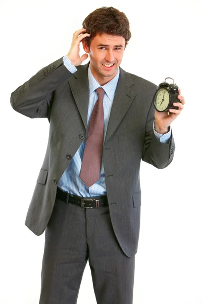 Concerned about time modern businessman with alarm clock — Stock Photo, Image