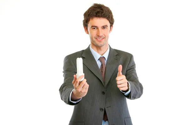 親指のジェスチャーを示す蛍光ランプを持ったビジネスマン — ストック写真