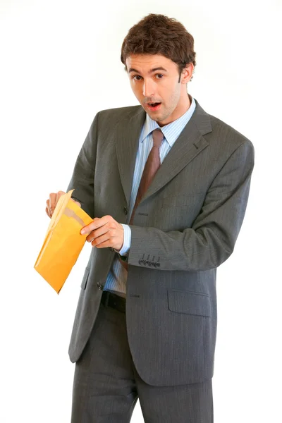 Shocked modern businessman checking parcel — Stock Photo, Image