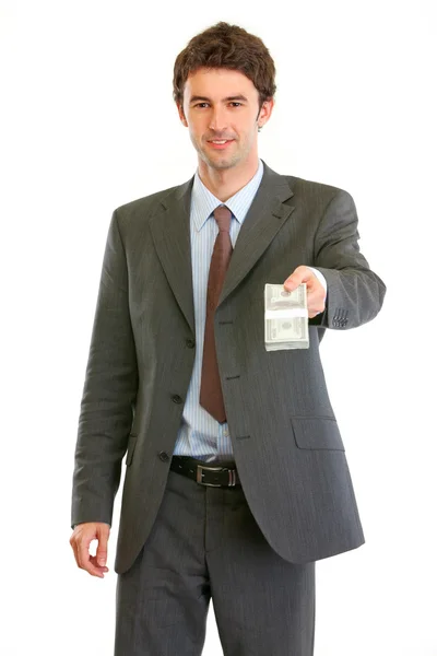 Modern businessman giving stack of dollars — Stock Photo, Image