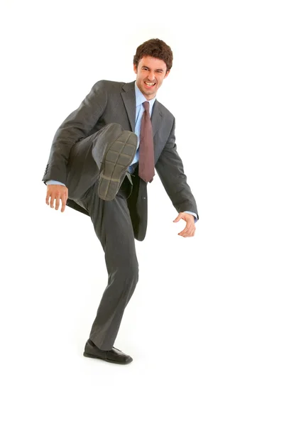 Portrait of very angry young businessman hard kicking — Stock Photo, Image