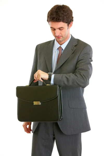 Modern businessman with briefcase checking time — Stock Photo, Image