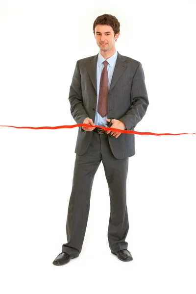 Full length portrait of smiling modern businessman cutting the r — Stock Photo, Image