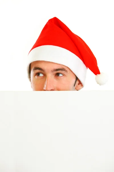 Nascondersi davanti al tizio del cartellone bianco a Santa Hat — Foto Stock