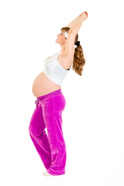 Sorrindo bela fêmea grávida fazendo exercícios de fitness — Fotografia de Stock