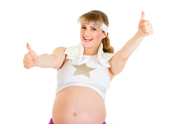 Χαμογελώντας όμορφη έγκυος γυναίκα σε αθλητικά ενδύματα εμφάνιση μπράβο χειρονομία — Φωτογραφία Αρχείου