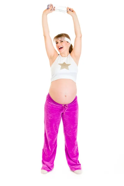 Happy beautiful pregnant female in sportswear holding bottle of pure water — Stock Photo, Image