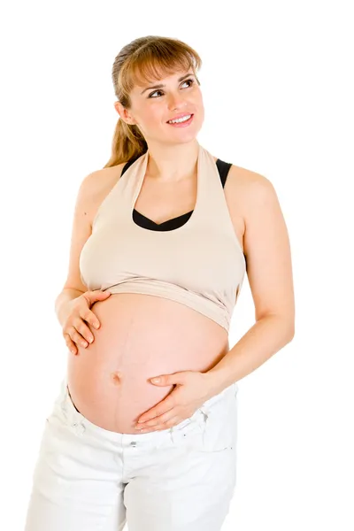Dromen mooie zwangere vrouw aan haar buik op wit wordt geïsoleerd te raken — Stockfoto